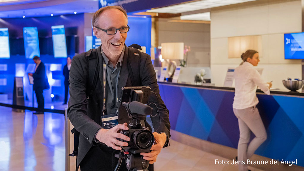 Cornelius Pfannkuch mit Kamera und Stativ bei den Dreharbeiten für den Eventfilm vom Eigenkapitalforum der Deutschen Börse